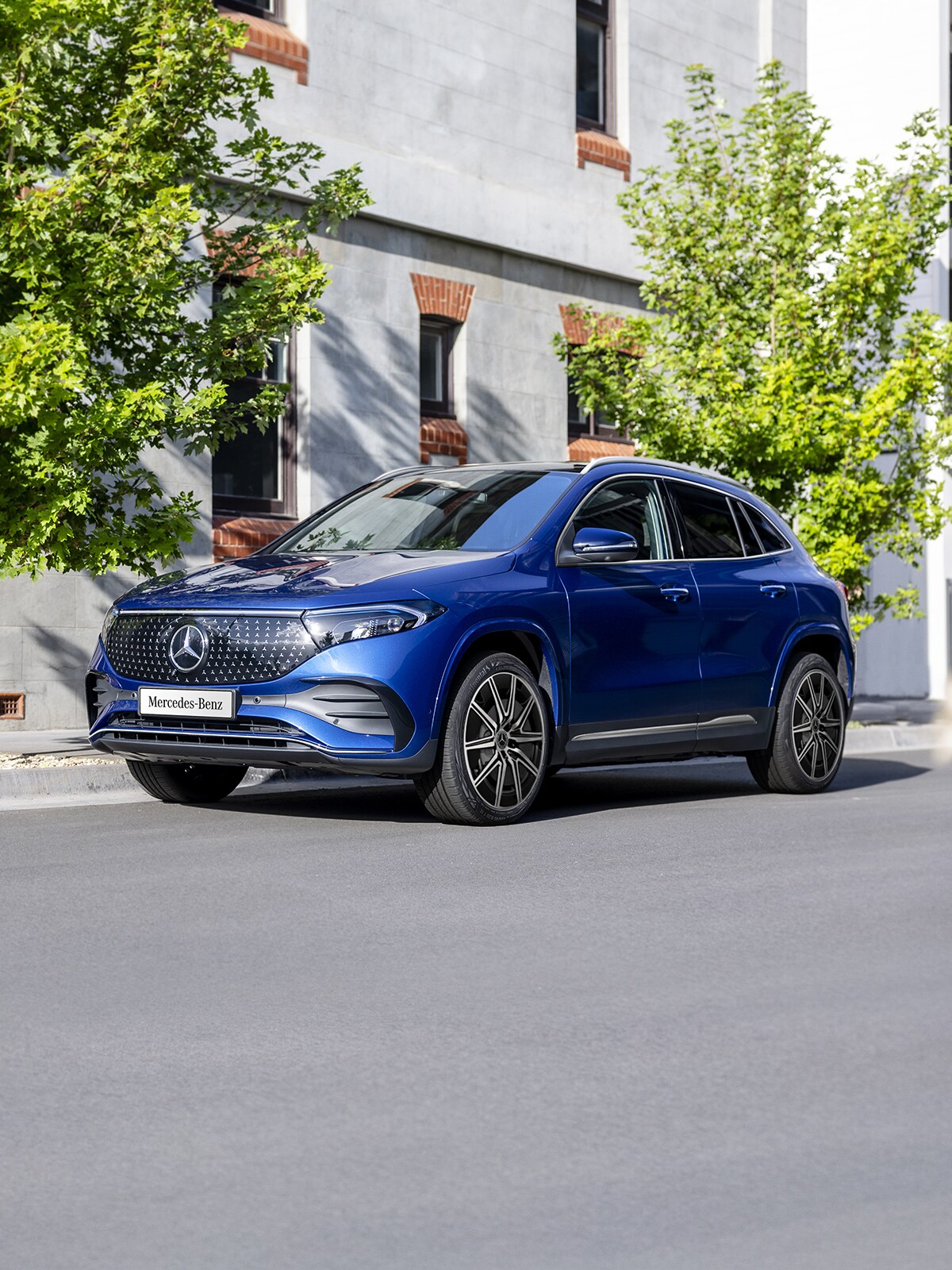 A blue EQA 250+ City Edition parked on the road side