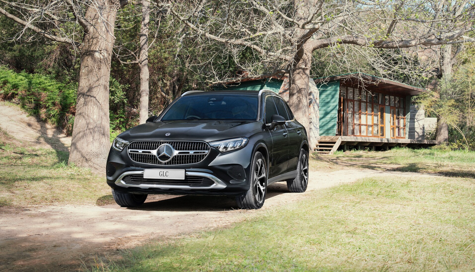 A black car parked on a dirt road