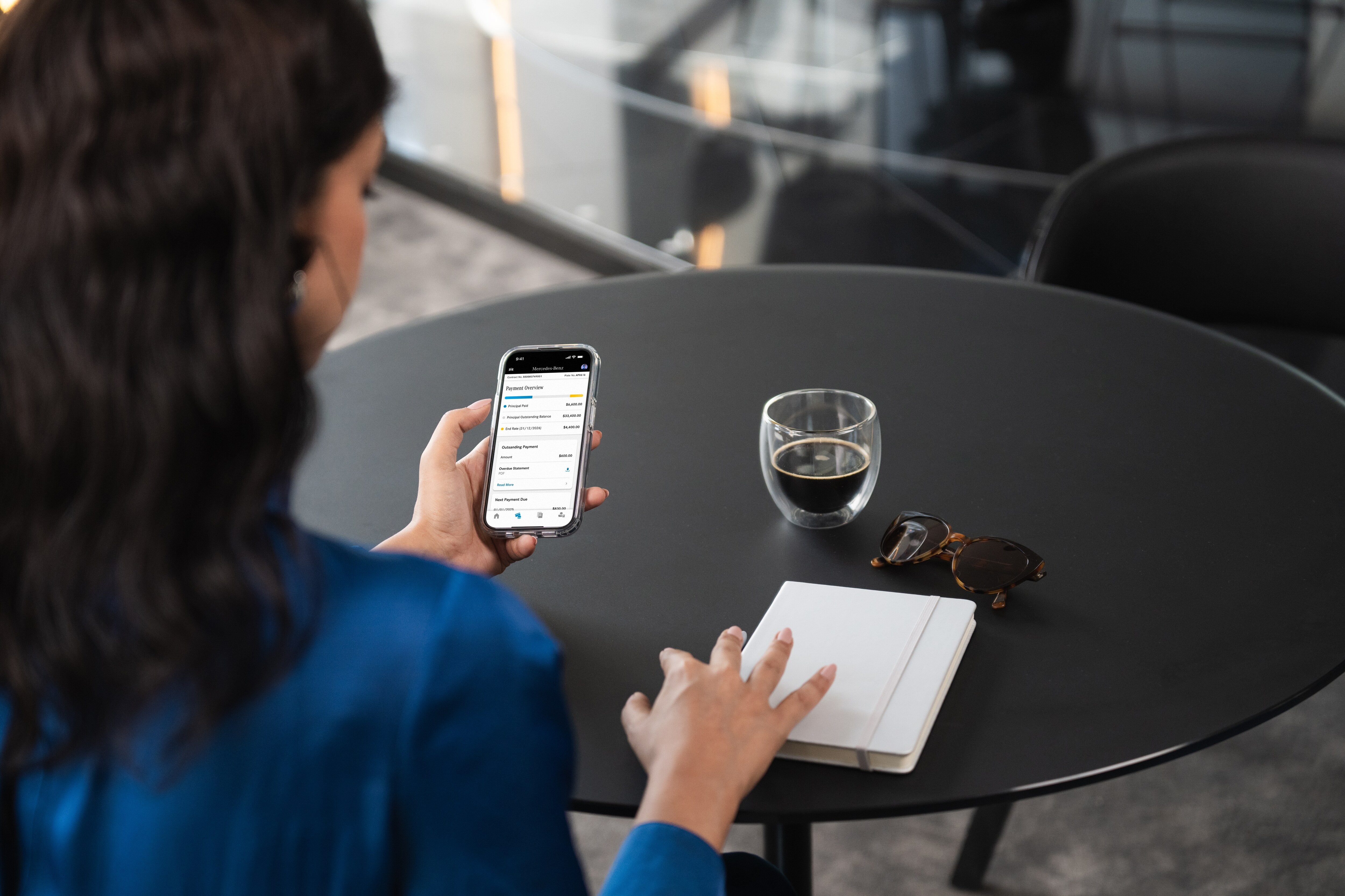 Hardship Assistance Person reviewing finance contract details on phone