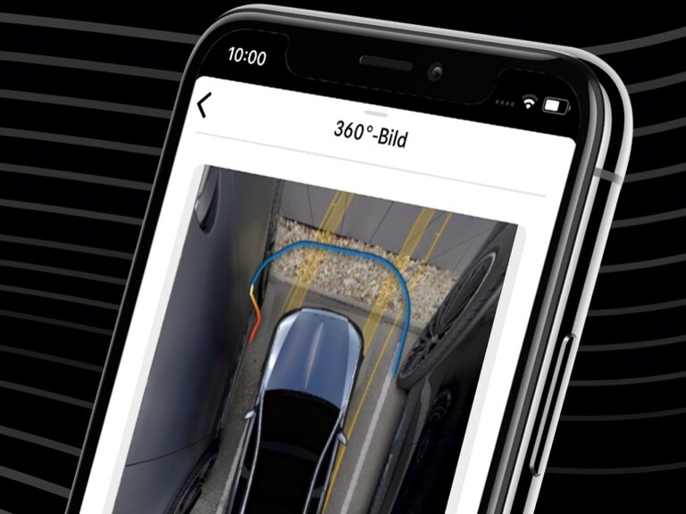 A Mercedes-Benz is conveniently steered into a tight parking space using the Mercedes me Remote Parking App and the 360° view on a smartphone. A Mercedes-Benz is conveniently steered into a tight parking space using the Mercedes me Remote Parking App and the 360° view on a smartphone.